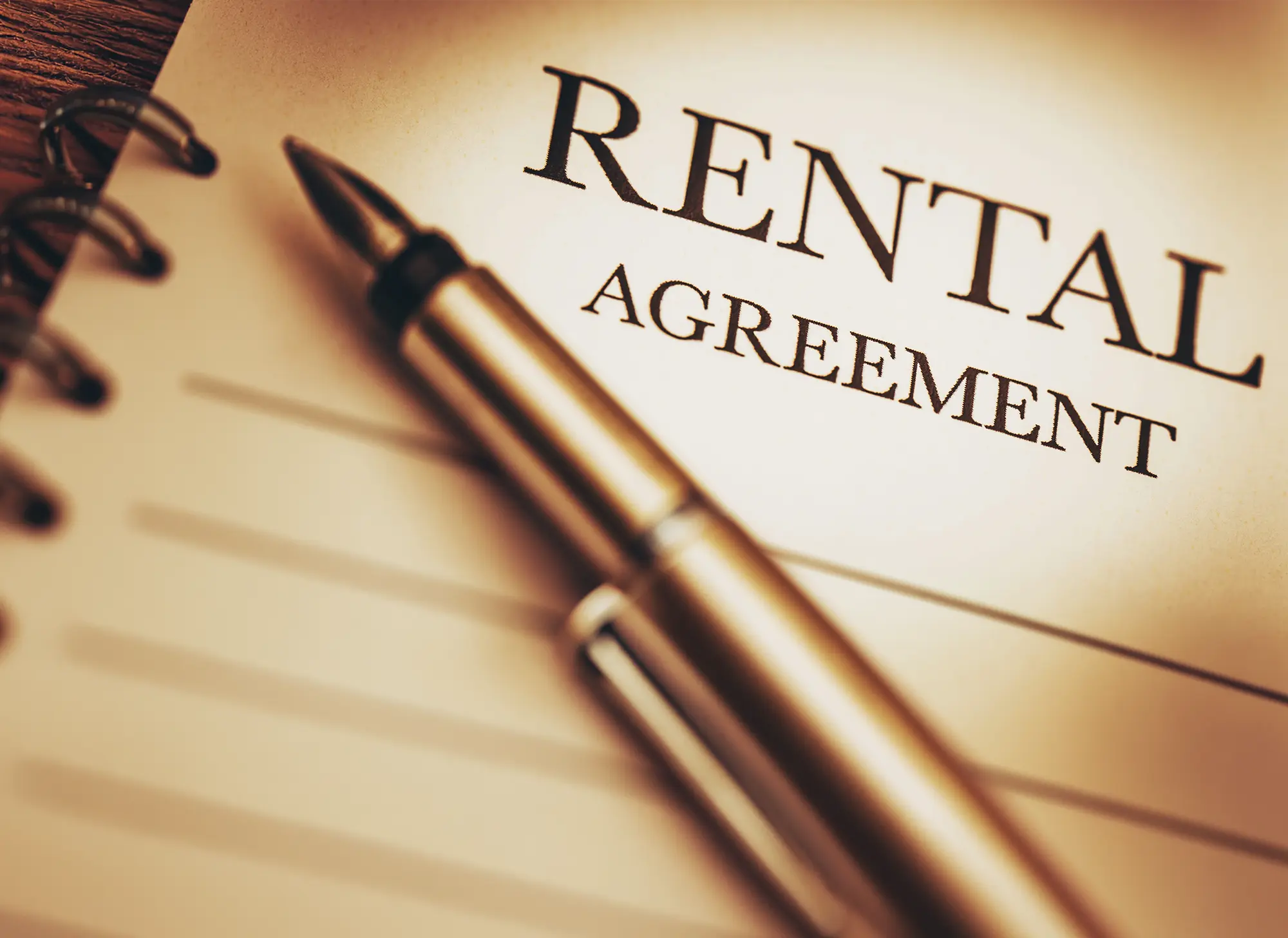 Pen resting on a rental agreement document