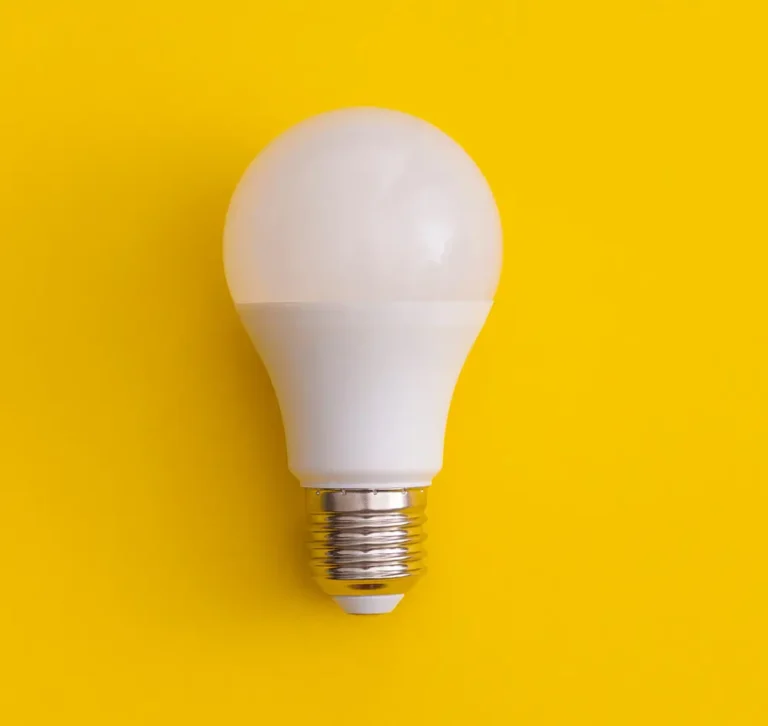 White LED light bulb on a bright yellow background