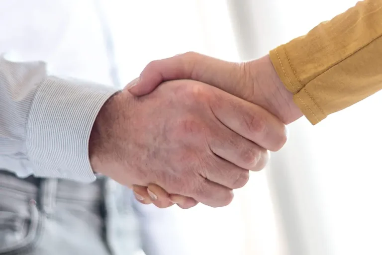 Close-up of two people shaking hands