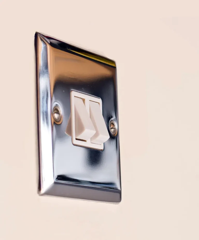 Double light switch on a chrome wall plate