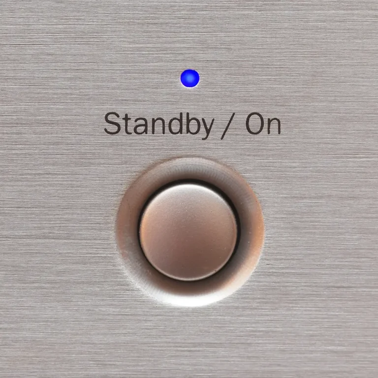 Blue-lit standby and on button on brushed metal panel