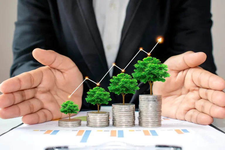 Businessperson protecting growing investments with trees, coins and rising graph
