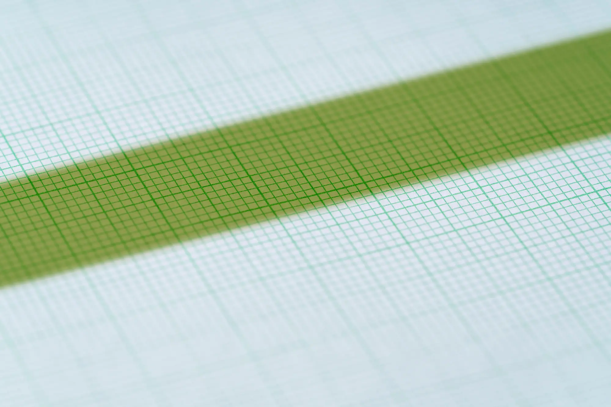 Green diagonal stripe on pale blue graph paper