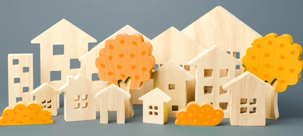 Wooden model houses, trees and bushes forming a neighbourhood